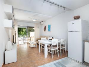 eine Küche und ein Esszimmer mit einem weißen Tisch und Stühlen in der Unterkunft Apartment Jardines Del Mar by Interhome in Marbella