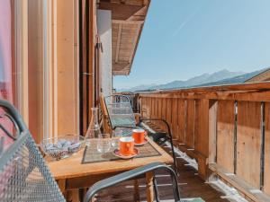 a table and chairs on the balcony of a house at Apartment Hajenuis TOP OG by Interhome in Königsleiten