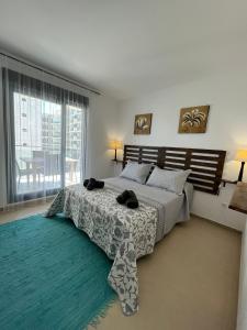 a bedroom with a bed and a large window at Cala Alta Sea Dreams in Benidorm