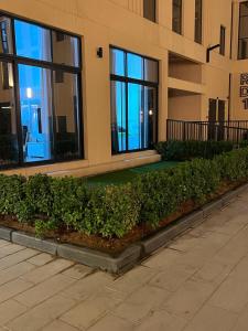 a building with a sidewalk in front of a building at Sharjah Brand New Apartment in Sharjah