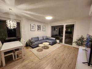 a living room with a couch and a table at BA Apartment with free garage parking, huge outside area in Bratislava