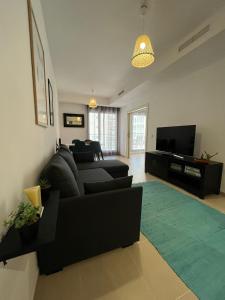 a living room with a couch and a television at Cala Alta Sea Dreams in Benidorm