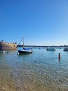a group of boats in the water on a beach at Villa à 900m des plages in Locquirec