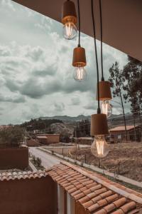 a group of lights hanging from a balcony at Casa Faustina - Templo de la Luna in Cusco
