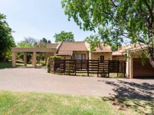 a house with a fence in front of it at 1 Bedroom Cottage in Midrand