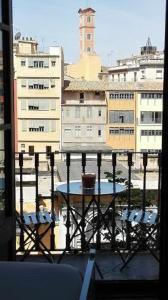 
a large building with a clock on the side of it at Bed & Breakfast Bells Oficis in Girona

