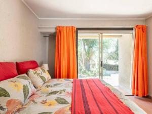 a bedroom with a bed and a large window at 1 Bedroom Cottage in Midrand