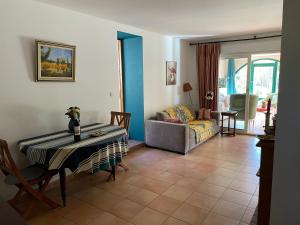 a living room with a table and a couch at La Bastide Dambrine in Sanary-sur-Mer