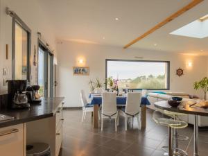 a kitchen and dining room with a table and chairs at Holiday Home Maison de Plain Pied - Vue Mer - TRP106 by Interhome in Kergador