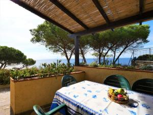 a table with a bowl of fruit on top at Apartment Oasis 1 by Interhome in Capoliveri