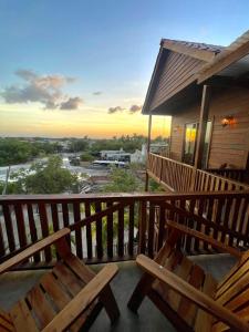 a porch with two wooden benches on a house at Krak-Inn Holbox - Pet Friendly in Holbox Island
