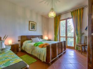 a bedroom with a bed and a large window at Holiday Home Allodola by Interhome in Scopeti