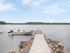 a boat is docked at a dock on a lake at Holiday Home Gapern - VMD044 by Interhome in Killstad