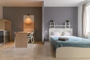 a bedroom with a bed and a desk in it at Euro Square Studios in Zagreb