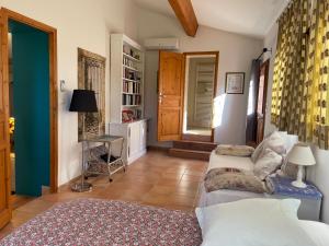 a bedroom with two beds and a table in it at La Bastide Dambrine in Sanary-sur-Mer