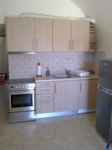 a kitchen with a stainless steel stove and cabinets at ANNA in Kastrisiánika