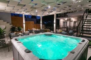 a hot tub on a patio with a table and chairs at Pargas Dream in Parga