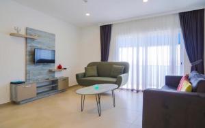 a living room with a couch and a table at Queen Victoria Suit Apart OTEL in Bodrum City