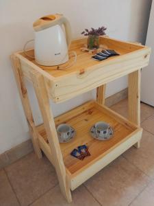 a small wooden table with a tea kettle on it at Lo de Mora in Cafayate
