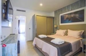 a bedroom with a bed with two towels on it at Queen Victoria Suit Apart OTEL in Bodrum City