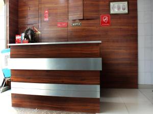a kiosk in a building with wood at Hotel Pearl in Karnal