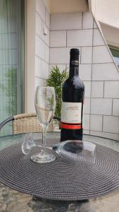 a bottle of wine and a glass on a table at Or suite sea side Eilat - אור סויט סי סייד אילת in Eilat