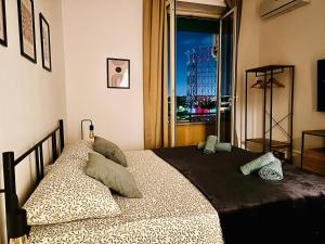 a bedroom with a bed with a view of a city at Attico lussuoso Roma centro in Rome