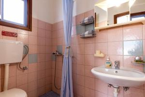 a bathroom with a sink and a shower at Katerina Studios Mparou in Apollonia