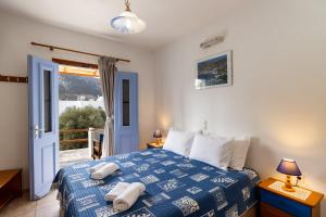 a bedroom with a bed with towels on it at Katerina Studios Mparou in Apollonia