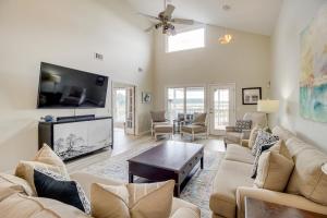 a living room with a couch and a tv at Riverfront Savannah Retreat with Private Dock! in Savannah