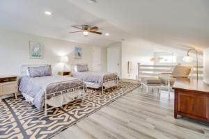 a bedroom with two beds and a desk and a piano at Riverfront Savannah Retreat with Private Dock! in Savannah