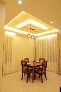 a dining room with a wooden table and chairs at The residence Ug in Bulindo