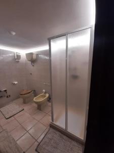 a bathroom with a toilet and a glass shower stall at La Dolce Volta in Tarquinia