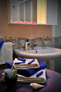 B&B L'Orizzonte في كاسترو دي ليتشي: حمام فيه مناشف على طاولة بجانب مغسلة