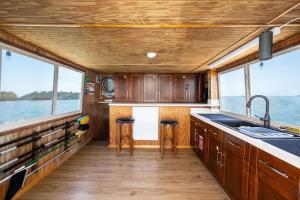 a kitchen with a counter and two stools at Beautiful Houseboat in Key West in Key West +35 photos