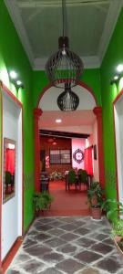 a green room with a table and chairs and a chandelier at La Borgoña (Hostal) in Salta