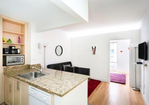 a kitchen with a sink and a counter top at Modern Two Bedroom At UES in New York
