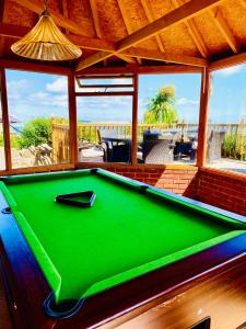 a green pool table in a room with a view at Villa Mentone Hotel in Shanklin