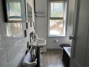 a white bathroom with a sink and a toilet at Heart of Hebden in Hebden Bridge