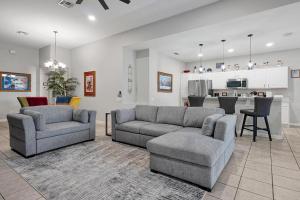 a living room with two couches and a kitchen at Windsor Hills 4BR's Mickeys Ranch Near Disney in Orlando
