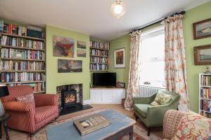 un salon avec cheminée et étagères dans l'établissement The Corner House, à Weymouth