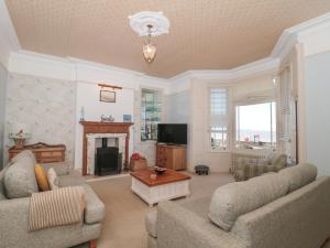 a living room with two couches and a fireplace at 49 Esplanade in Burnham on Sea