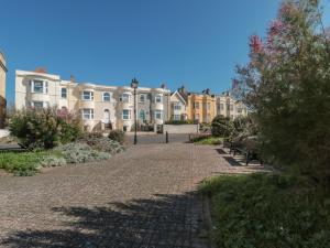 a cobblestone street in front of a row of houses at 49 Esplanade in Burnham on Sea