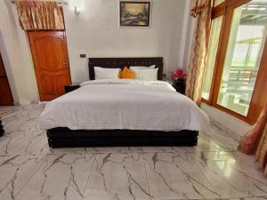a bedroom with a large bed with a marble floor at Swat Hilton Hotel by Khan Familia in Swat