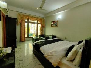 a bedroom with a large bed and a window at Swat Hilton Hotel by Khan Familia in Swat