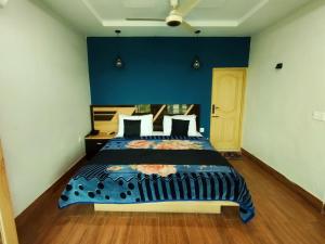 a bedroom with a large bed with a blue wall at Swat Hilton Hotel by Khan Familia in Swat