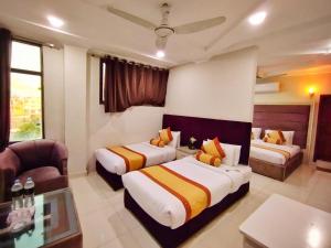 a hotel room with two beds and a couch at Swat Hilton Hotel by Khan Familia in Swat