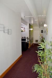 an empty hallway with plants in an office at Hot Springs Hotel & Spa in Thermopolis