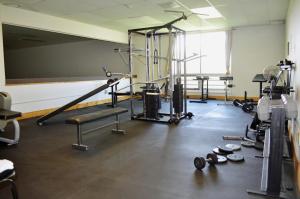 a gym with weights and equipment in a room at Hot Springs Hotel & Spa in Thermopolis