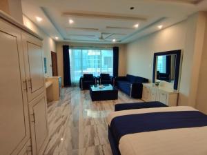 a hotel room with two beds and a living room at Swat Hilton Hotel by Khan Familia in Swat
